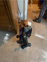 Lot overview showing handcrafted shoe valet, travel kit, leg exerciser machine and shoe polish set