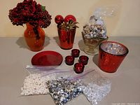 Full lot showing vases, candle holders, decorative bags, and glass compote with natural elements