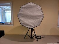 Full view of the round octagonal white diffusion light reflector mounted on a black tripod stand, showing overall size and structure.