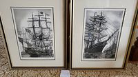 Two framed etchings side by side showing tall ships with sails and rigging, signed Alan Jay Gaines
