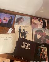 Top-down photo showing seven vinyl albums by artists including Sammy Hagar, Fleetwood Mac, The Doors, Emerson Lake & Palmer, Brain Salad Surgery, and Bob Dylan.