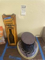 Whole lot showing wine holder, margarita glass, and one of the black Happy New Year paper hats on a silver tray.