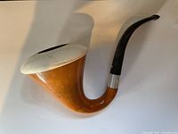 Side view of the Calabash Meerschaum pipe showing white bowl rim, wooden body, and curved black stem with metal band.