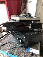 Stacked Sony ELITE receiver, Pioneer DVD player, and Sony turntable on countertop, showing front panels and cables.