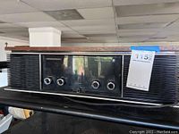 Front left angle view of vintage Panasonic stereo multiplex receiver showing the wood top, black front panel with control knobs, and speaker grilles.