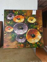 Full view of the square canvas painting showing multiple flowers in orange, yellow, and purple on a dark green background.
