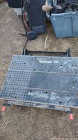 Work surface of Black & Decker Workmate 550 portable project center showing grid patterns, clamps, and wear marks.