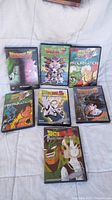 Photo of seven Dragon Ball Z DVD cases arranged on surface showing front covers of each.