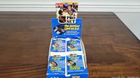 Display box showing multiple sealed packs of 1990 Pro Set Series 1 NHL hockey cards stacked inside.
