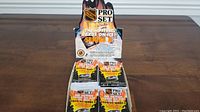 Photo of the box holding multiple sealed packs of 1990/91 Pro Set Series 2 NHL hockey cards with flaming design and NHL logo