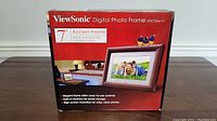 Front photo of the ViewSonic 7 inch Digital Photo Frame box showing product branding, model number VPD724w-11, and product features.