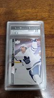 Front view of encapsulated Auston Matthews hockey card graded 10 by SMA showing player mid-celebration with Toronto Maple Leafs jersey