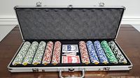 Open poker set with five rows of poker chips in white, brown, blue, and green with Bass Pro Shops logo, two decks of BCG playing cards.