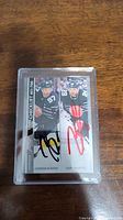 Front of autographed dual player hockey card featuring Connor McDavid and Leon Draisaitl, in clear protective case