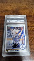 Front of Curtis Joseph rookie hockey card, showing Curtis Joseph in St. Louis Blues gear with blue signature, encased in plastic slab with SMA grading 7 label.