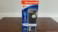 Front view of the Honeywell Slim Tower Fan box showing the fan image, brand, and highlighting QuietSet control features.
