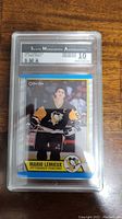 Front view of the Mario Lemieux hockey card showing player photo, name, and team logo, encased in SMA graded slab with a '10' grade.