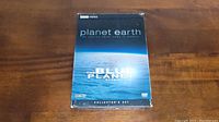 Front view of Planet Earth Collector's Set DVD box showing cover art depicting earth and text details.