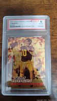 Front of Tom Brady rookie card in black and gold uniform, showing Gold Refractor reflective surface, encased in WCG graded slab.