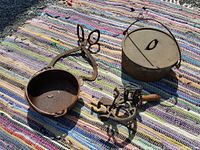 Full lot shot showing all four items on a multicolored woven mat outdoors including pots, ice tongs, and peeler