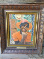 Full view of framed oil painting showing the subject, frame, and background environment.