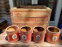 Wooden Canada Dry crate with four Prince Albert tobacco cans placed in front