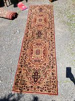 Full view of the long narrow runner rug laid flat on the ground, showing the overall design and colors.