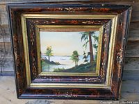 Framed vintage watercolour of a lake scene with islands, trees, and signature visible.