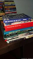 Stack of various architecture books showing titles 'The Making of an Icon' and 'Pentagram Book Five'.