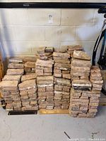 Front view of stacked assorted Chicago bricks showing wear and rough surfaces