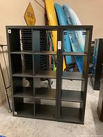 Front view of two black cube shelving units side by side showing compartment arrangement and overall dimensions.