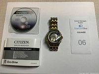 Top view photo showing the watch, original instruction manual, and instructional CD for Citizen Eco-Drive Minute Repeater CTZ-B8108.
