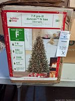 Photo of the front side of the box with tree details including height, number of lights and branch tips and diameter.