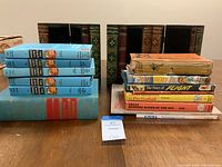 Front view of all books including Hardy Boys, sports, and decorative wooden storage boxes resembling books