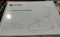 Photo of the unopened white box of the Fit King Air Compression Leg Massager model FT-009A. Box shows product features and illustration of the leg massager with attached remote.