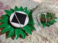 Photo of green solar powered pineapple lights with solar panels and wrapped parts