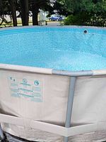 Corner angle of assembled pool showing beige frame and blue interior liner