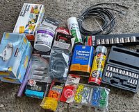Overview of various hardware, automotive sprays, sanding materials, and socket wrench set.
