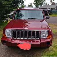 Front view showing chrome seven-slot grille, headlights and front bumper