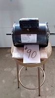 Photo shows the full electric motor on a stool with a note labeled #90.