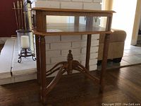 Full view of antique wooden display table with glass case top and spindle legs