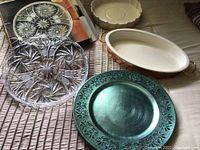 The lot as shown from above with crystal dish, green chargers, bronze tray with sole dish, additional ceramic serving dish.
