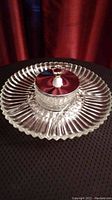 Top view of the Lazy Susan serving dish showing the chrome-finished lid with decorative handle and the fluted glass dish surrounding it.