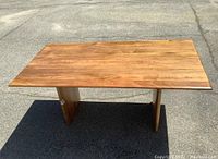 Front view of table showing rectangular top and slab legs