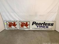 Pair of two rectangular metal advertising signs placed on the ground against a white backdrop showing full front view