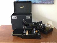 Overall view of machine outside case with accessories tray and oil