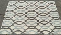 Full top view of the West Elm Ikat Links rug showing the linked oval ikat pattern in grays and off-white.
