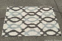Full view of rectangular wool rug laid flat showing complete pattern and colors.