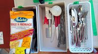 Flatware including spoons and forks in white baskets, cheesecloth package in box