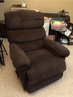 Front view of brown corduroy La-Z-Boy recliner showing cushioned seat, armrests, and headrest cover.